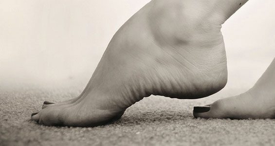 Bare feet resting on soft carpet